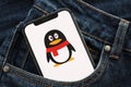 KYIV, UKRAINE - APRIL 1, 2024 Tencent QQ icon on smartphone display screen in jeans pocket