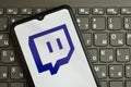 KYIV, UKRAINE - APRIL 1, 2024 Twitch icon on smartphone screen on black keyboard