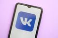 KYIV, UKRAINE - APRIL 1, 2024 Vkontakte icon on smartphone screen on purple table