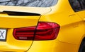 Kyiv. Ukraine. April 2024. Yellow BMW car close-up. LED tail light bulb of a car. the rear light