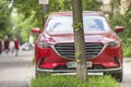 Kyiv, Ukraine - August 25, 2018: Car parked in pedestrian zone under trees on city street with walking people on summer day Royalty Free Stock Photo