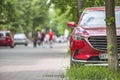 Kyiv, Ukraine - August 25, 2018: Car parked in pedestrian zone under trees on city street with walking people on summer day Royalty Free Stock Photo