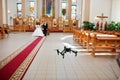 Kyiv, Ukraine - August 31: DJI Inspire Pro drone quadcopter recording on video wedding couple on church at wedding day.