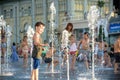 KYIV, UKRAINE AUGUST 13, 2017: Happy kids have fun playing in city water fountain on hot summer day. Royalty Free Stock Photo