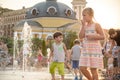 KYIV, UKRAINE AUGUST 13, 2017: Happy kids have fun playing in city water fountain on hot summer day. Royalty Free Stock Photo