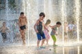 KYIV, UKRAINE AUGUST 13, 2017: Happy kids have fun playing in city water fountain on hot summer day. Royalty Free Stock Photo