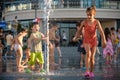 KYIV, UKRAINE AUGUST 13, 2017: Happy kids have fun playing in city water fountain on hot summer day. Royalty Free Stock Photo