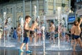 KYIV, UKRAINE AUGUST 13, 2017: Happy kids have fun playing in city water fountain on hot summer day. Royalty Free Stock Photo