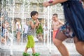 KYIV, UKRAINE AUGUST 13, 2017: Happy kids have fun playing in city water fountain on hot summer day. Royalty Free Stock Photo