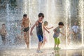 KYIV, UKRAINE AUGUST 13, 2017: Happy kids have fun playing in city water fountain on hot summer day. Royalty Free Stock Photo