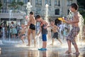 KYIV, UKRAINE AUGUST 13, 2017: Happy kids have fun playing in city water fountain on hot summer day. Royalty Free Stock Photo