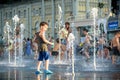 KYIV, UKRAINE AUGUST 13, 2017: Happy kids have fun playing in city water fountain on hot summer day. Royalty Free Stock Photo