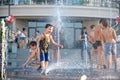 KYIV, UKRAINE AUGUST 13, 2017: Happy kids have fun playing in city water fountain on hot summer day. Royalty Free Stock Photo