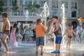 KYIV, UKRAINE AUGUST 13, 2017: Happy kids have fun playing in city water fountain on hot summer day. Royalty Free Stock Photo