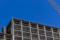 Professional high-rise installers buildings work on the top floor of a building under construction. Royalty Free Stock Photo