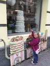 Sweet tooth girl cannot pass by a shop window with a giant cake