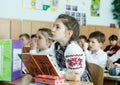 Classroom with pupils in school clothes with young attractive teacher in ukrainian school. School life,