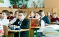 Classroom with pupils in school clothes with young attractive teacher in ukrainian school. School life,