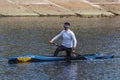 Kyiv Ukraine, the Dnieper River - March 28 2020: Unknown young athlete is swimming in a canoe.