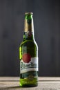 Bottle of Pilsner Urquell beer on a wooden background. Pilsner Urquell is a Czech lager brewed by