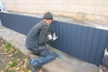 Building Contractors with Foundation repair. Foundation wall repair and renovation with installing metal sheets for waterproofing