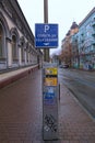 Parking machine with electronic payment in the central part of the city. Text on sign: Pay for parking here Royalty Free Stock Photo