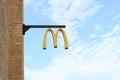 A sign of the American fast food restaurant chain McDonald\'s on the wall Royalty Free Stock Photo