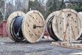 Wooden drums of electric cables, optical fibres on the construction site. Spool of cabels Royalty Free Stock Photo