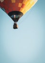 Hot air balloon in clear blue sky, vertical, filtered. Colorful balloon with basket lift up, toned with vignette. Royalty Free Stock Photo