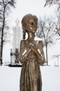 Kyiv, Ukraine - JAN 2019: Close-up of child holding spikelet monument in front of National Museum of Holodomor Genocide