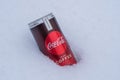 Can of Coca-Cola plus coffee on a bed of snow and white background Royalty Free Stock Photo