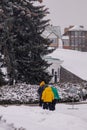 the city is covered in snow, but people still go out for a walk on the day off.