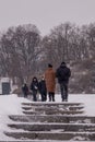 the city is covered in snow, but people still go out for a walk on the day off.