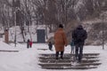 the city is covered in snow, but people still go out for a walk on the day off.