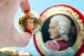 KYIV, UKRAINE - JANUARY 29, 2022: Woman takes Mozart candies from an open candy box. Royalty Free Stock Photo