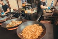 Asian food with frying pans full of vermicelli in a cafe during popular outdoor Street Food Festival Royalty Free Stock Photo