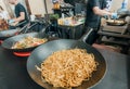 Fine dried noodles in pan of asian fast-food cafe during popular outdoor Street Food Festival