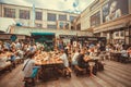 Many tables with friendly party people eating and drinking during outdoor Street Food Festival Royalty Free Stock Photo