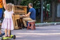 Kyiv Ukraine - Jule 27 2019: Unidentified musician plays on a piano on Mikhailovskaya Square in the center of Kyiv.