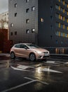 beige SEAT Ibiza in front of the corner of anthracite modern building. Royalty Free Stock Photo