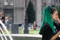 Kyiv, Ukraine, July 6, 2019: Trendy girl posing with green hair and little african pigtails