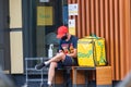 Kyiv Ukraine - July 17 2020: A young courier from a delivery service waits to receive an order outside a fast food restaurant. Qua