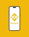 Kyiv, Ukraine - 07 June 2023: Binance cryptocurrency exchange app on the smartphone iPhone 14 screen with yellow background.