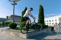 Bmx biker performing tricks and stunts training in city park. Jump on bmx bike in action Royalty Free Stock Photo