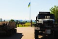 Xhibition of destroyed russians armored vehicles. The biggest National flag of Ukraine in the background