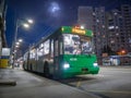 Green trolleybus on the street of Kyiv in the residential area of Troyeschina at night. Trolleybus Royalty Free Stock Photo