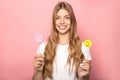 KYIV, UKRAINE - JUNE 7, 2019: woman holding smiling emoji and Instagram sign isolated on pink