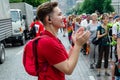 Kyiv, Ukraine - June 23, 2019. March of equality. KyivPride. The girl in red coordinates the action of the marchers