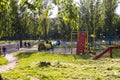 KYIV, UKRAINE Ã¢â¬â JUNE 1, 2020. Poplar fluff lies in the green grass and flies through the air in the playground. Children and