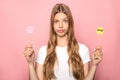 KYIV, UKRAINE - JUNE 7, 2019: woman holding emoji in sunglasses and Instagram sign isolated on pink